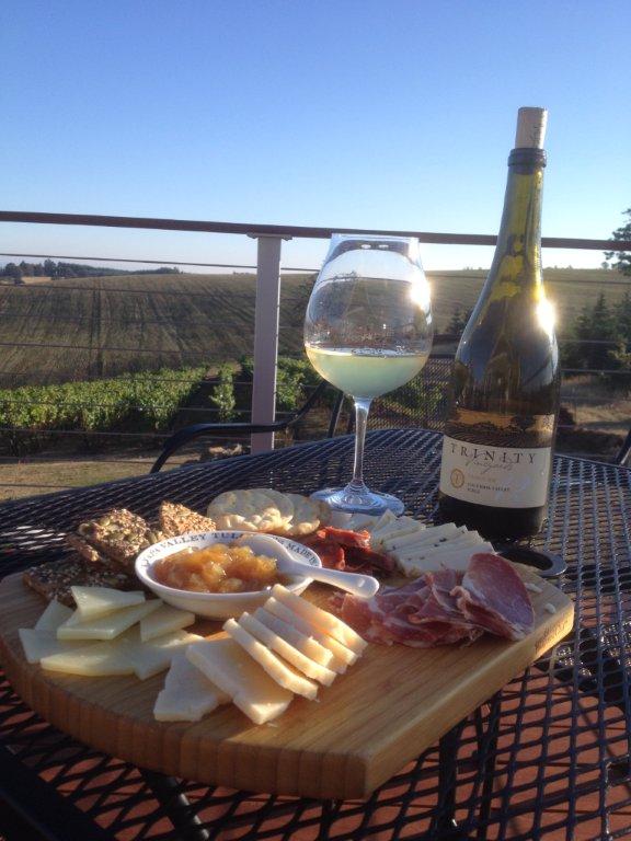 A wine glass and cheese board on the patio.
