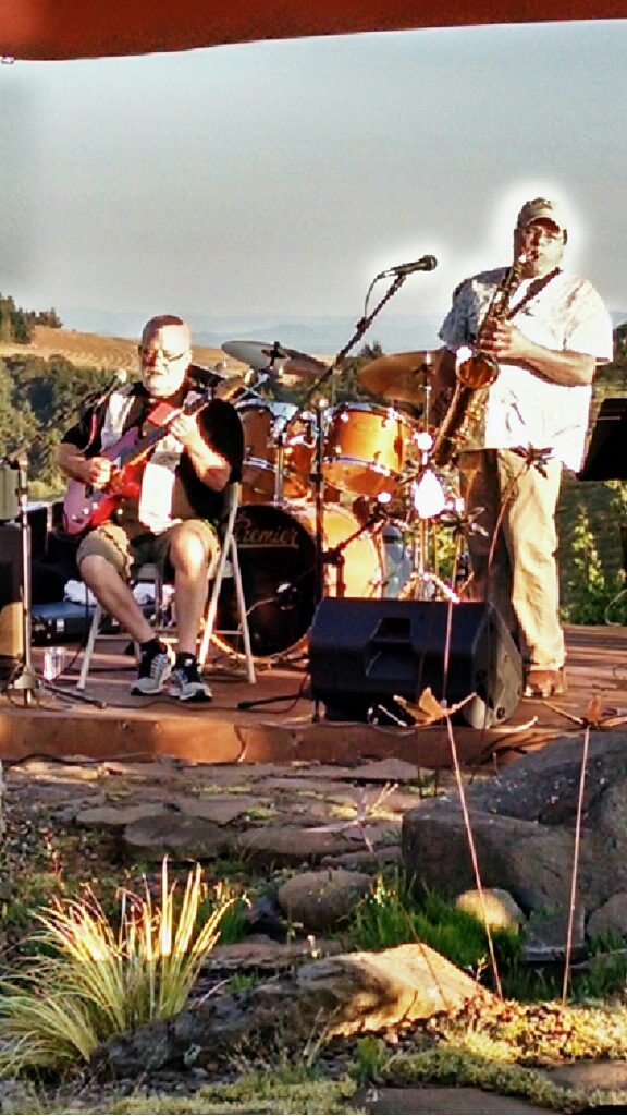 A man and woman playing instruments on stage.