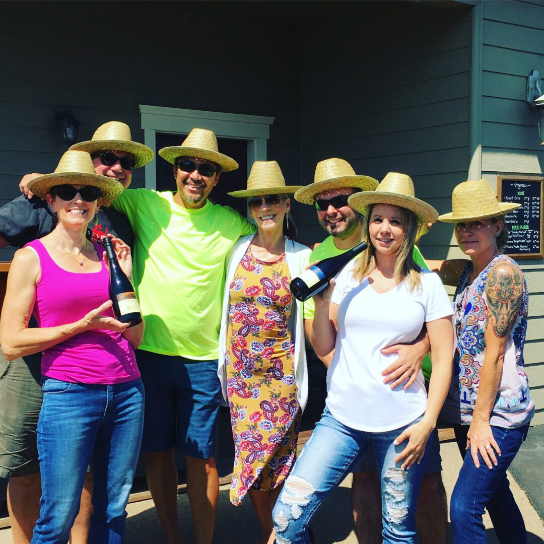 A group of people standing next to each other wearing hats.