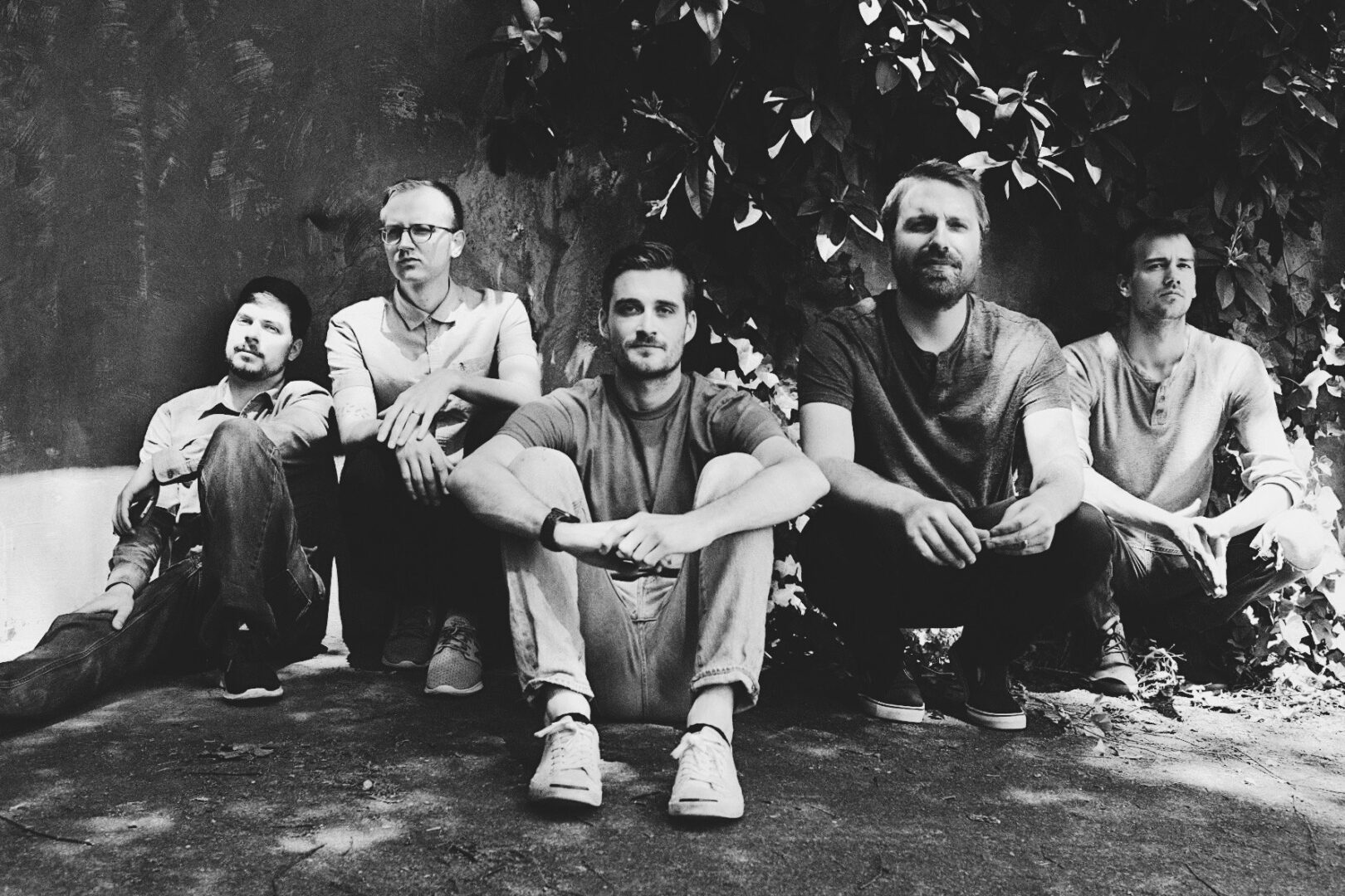 A group of people sitting on the ground.