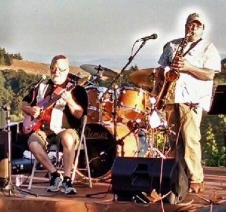 Two men playing instruments on a stage.