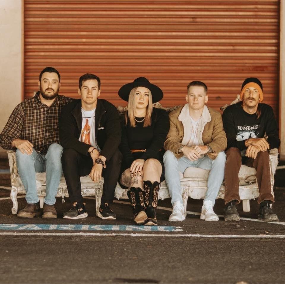 A group of people sitting on top of a bench.